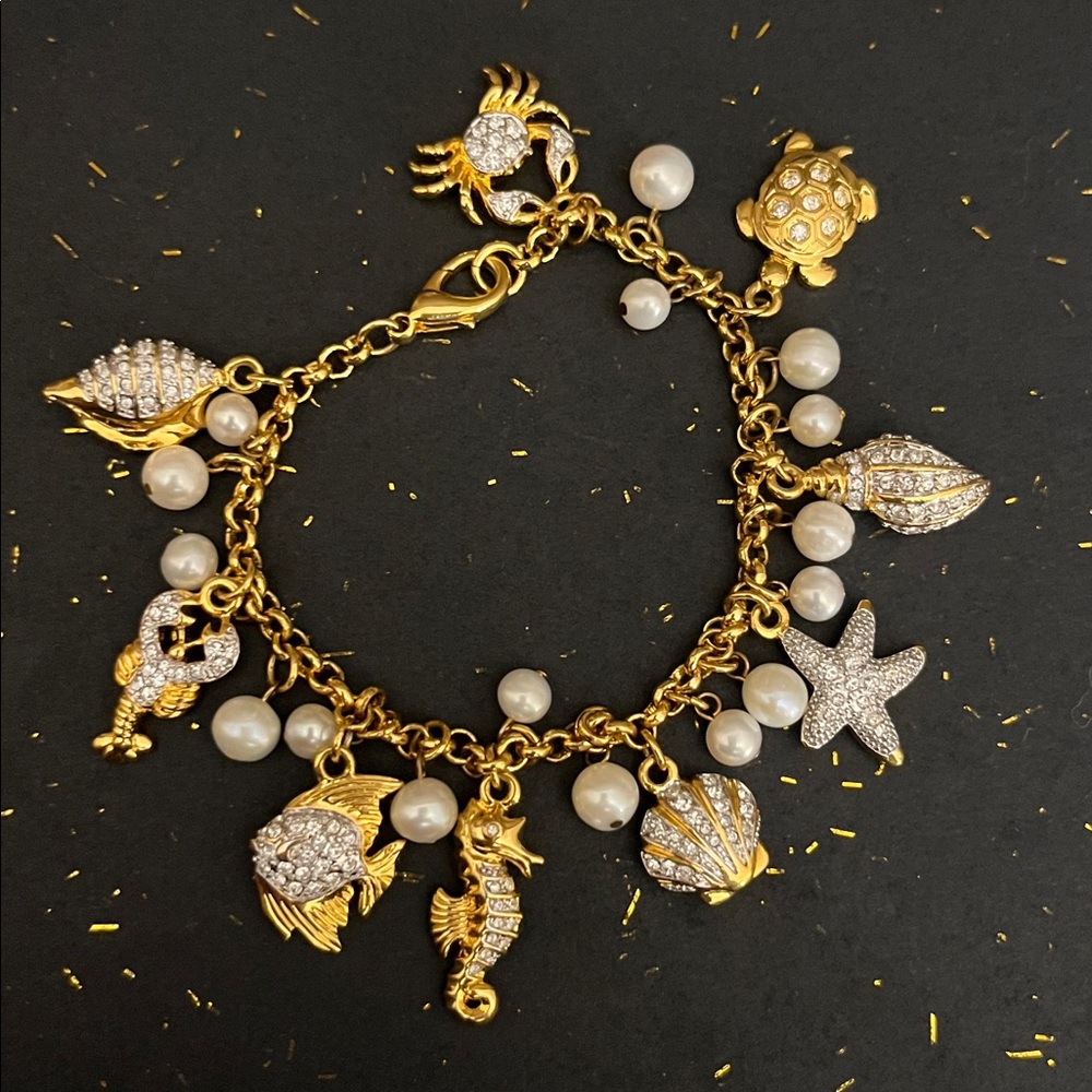 Gold tone charm bracelet pearls and  sea life creatures studded in tiny crystals